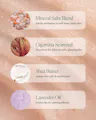 A close-up of a pinkish-beige textured cosmetic product with four labeled ingredient callouts: Mineral Salts Blend, Gigartina Seaweed, Shea Butter, and Lavender Oil, each with a small circular inset showing the ingredient texture.