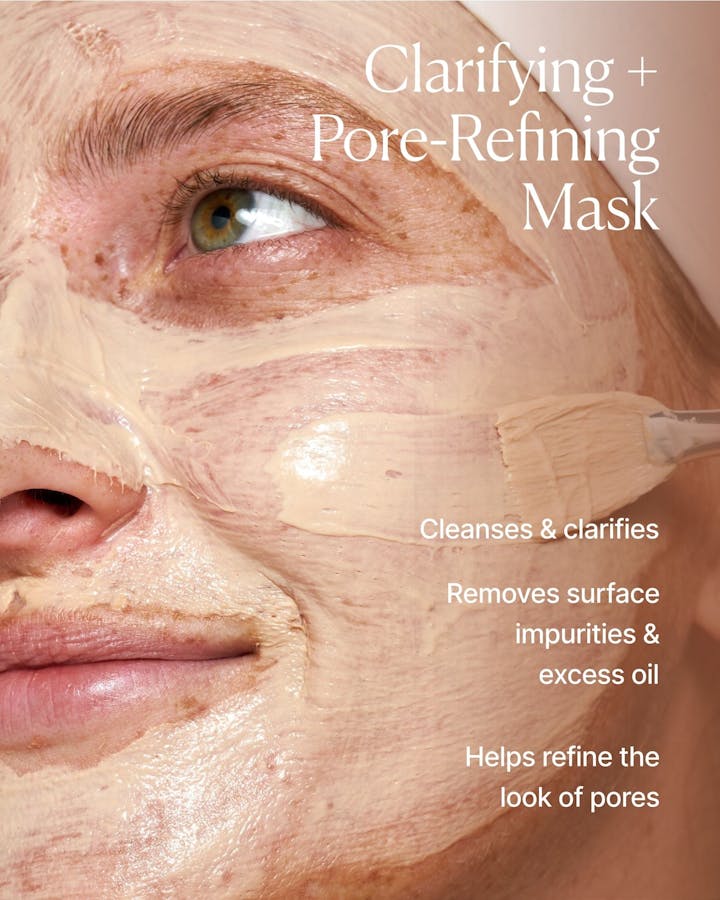 Person applying a clarifying and pore-refining mask to their face with text describing the product's benefits.