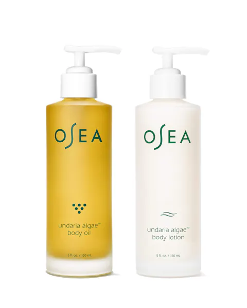 Two OSEA body care products, one yellow body oil and one white lotion, on a white background.