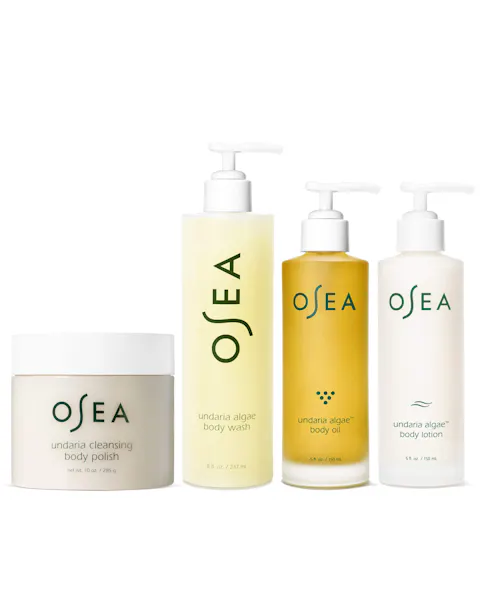 Set of OSEA skincare products including a jar, body wash, oil, and lotion on a white background.