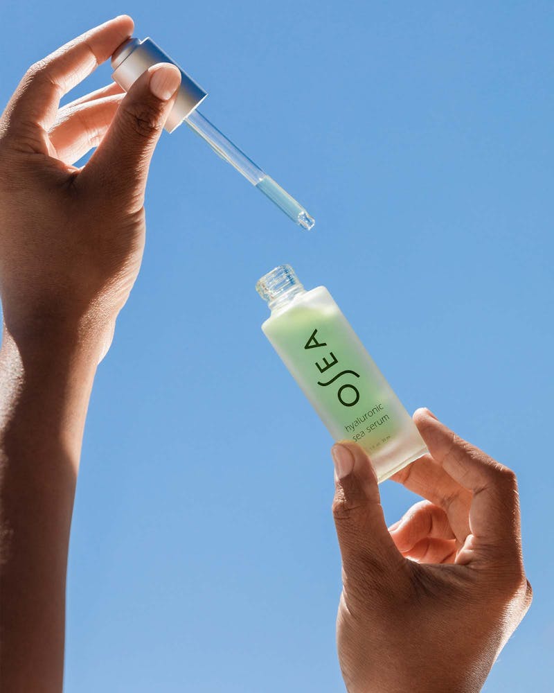 A bottle of OSEA hyaluronic sea serum with a white label and green cap.