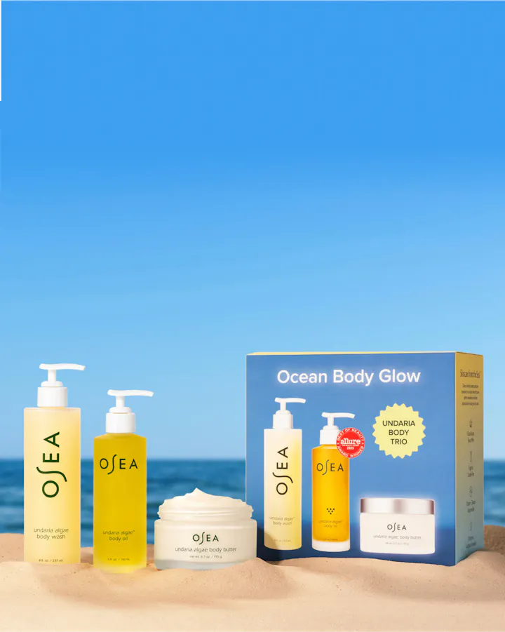 OSEA skincare products with packaging on a beach setting