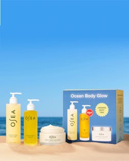 OSEA skincare products with packaging on a beach setting