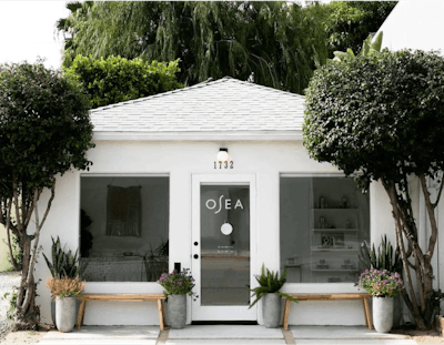 A Small White Building With Plants