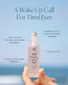 OSEA eye serum bottle held by a hand with product features highlighted on a blue background