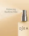 Osea balancing bedtime mist bottle on a beige background