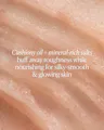 Close-up of a skin texture with text describing cushiony oil and mineral-rich salts for skincare.