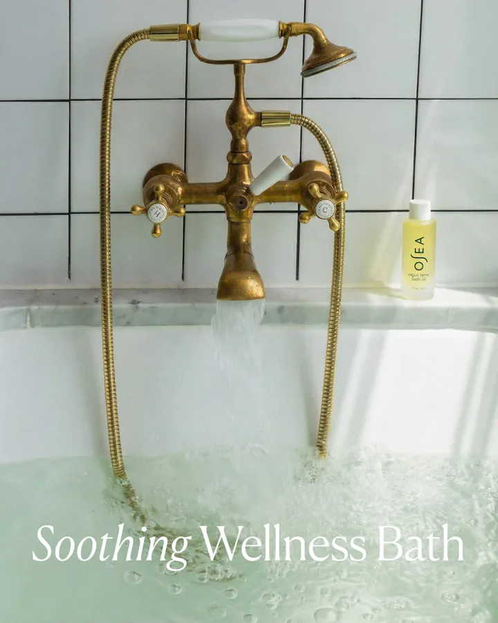 Gold bathtub faucet with running water, OLEA bottle, and 'Soothing Wellness Bath' text.