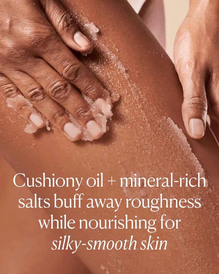 Close-up of hands applying cushiony oil and mineral-rich salts to skin with text describing its benefits.