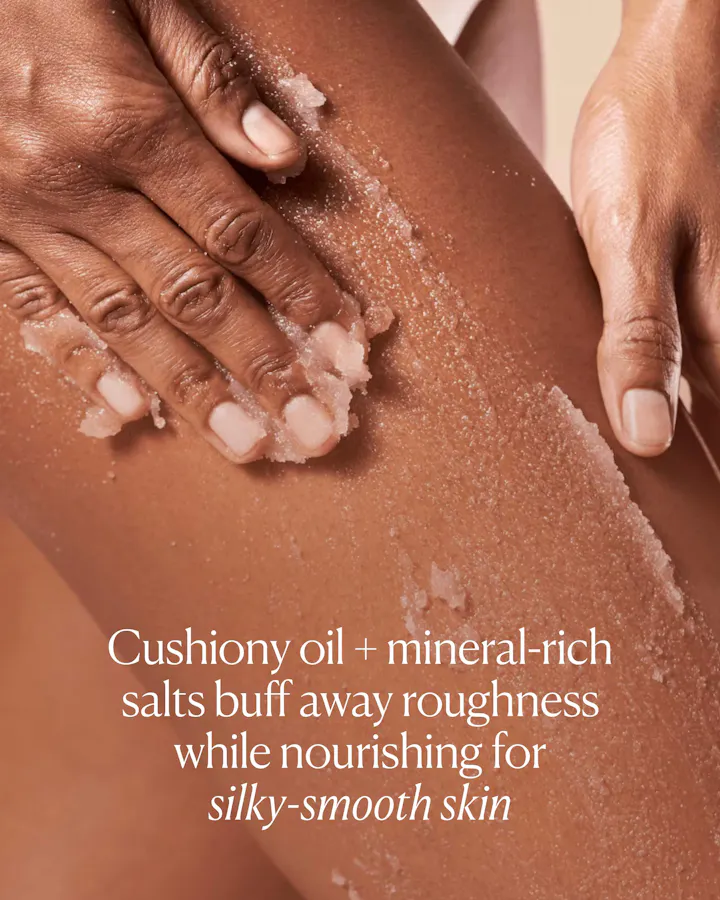Person scrubbing their skin with a cushiony oil and mineral-rich salt product.
