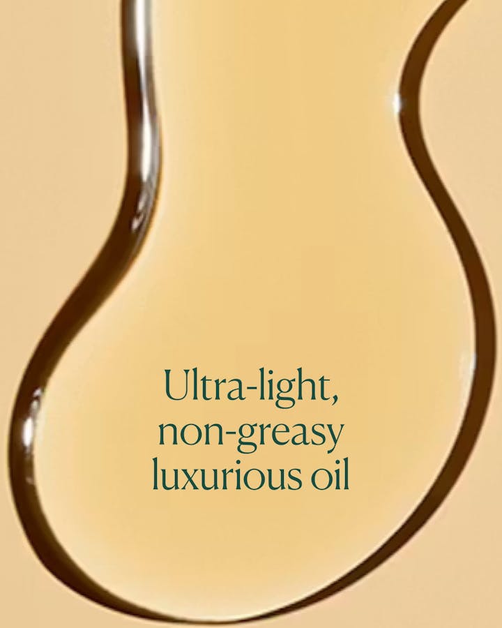 Close-up of a droplet of ultra-light, non-greasy luxurious oil with text overlay on a beige background.
