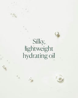 Text 'Silky, lightweight hydrating oil' on a light background with small droplets.