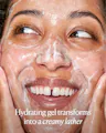Person applying a hydrating gel to their face with text overlay.