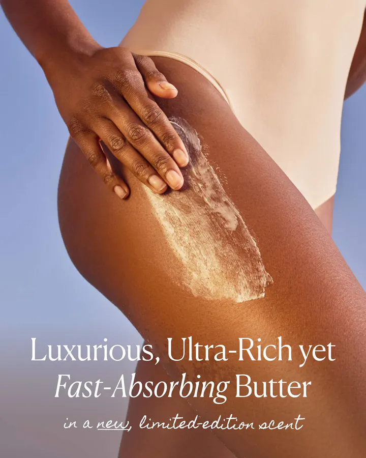 Close-up of a hand smoothing OSEA Undaria Algae Body Butter onto the hip and thigh, showing the rich, blendable texture, with text reading 'Luxurious, Ultra-Rich yet Fast-Absorbing Butter in a new, limited-edition scent.'
