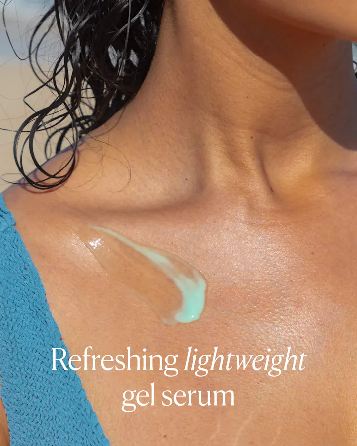 Close-up of OSEA Hyaluronic Body Serum's mint-green gel texture swiped onto skin near the collarbone, with text reading 'Refreshing lightweight gel serum.