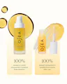 OSEA undaria algae body oil shown in two pump bottles with applicator, set against a pale cream background with golden liquid droplets and text claiming 100% improvement in moisture and skin elasticity.