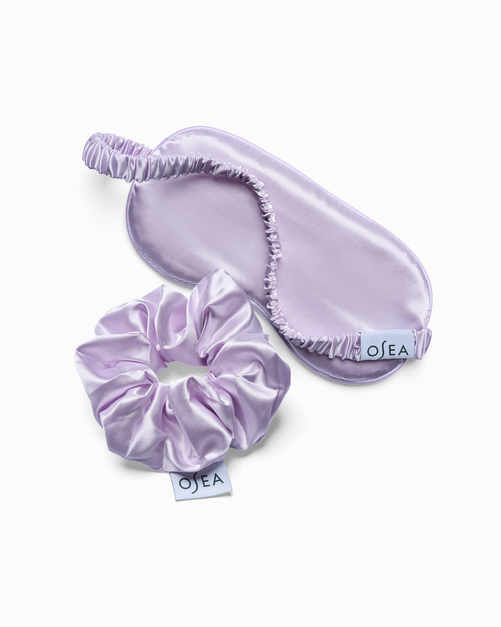 Set of lavender satin eye mask and scrunchie with 'Olea' branding on a white background