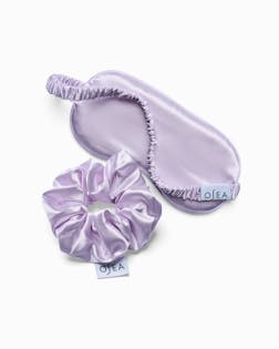 Set of lavender satin eye mask and scrunchie with 'Olea' branding on a white background
