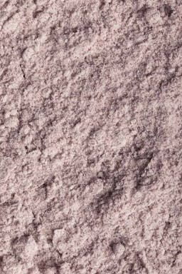 A Close Up Of A Light Purple Powder