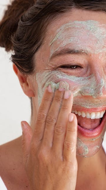 Smiling woman with smooth skin using Seaglow Resurfacing Scrub