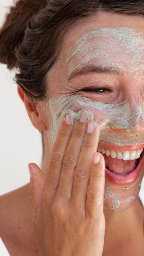 Smiling woman with smooth skin using Seaglow Resurfacing Scrub