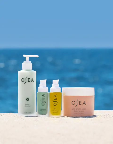Three OSEA products on a beach with ocean in the background