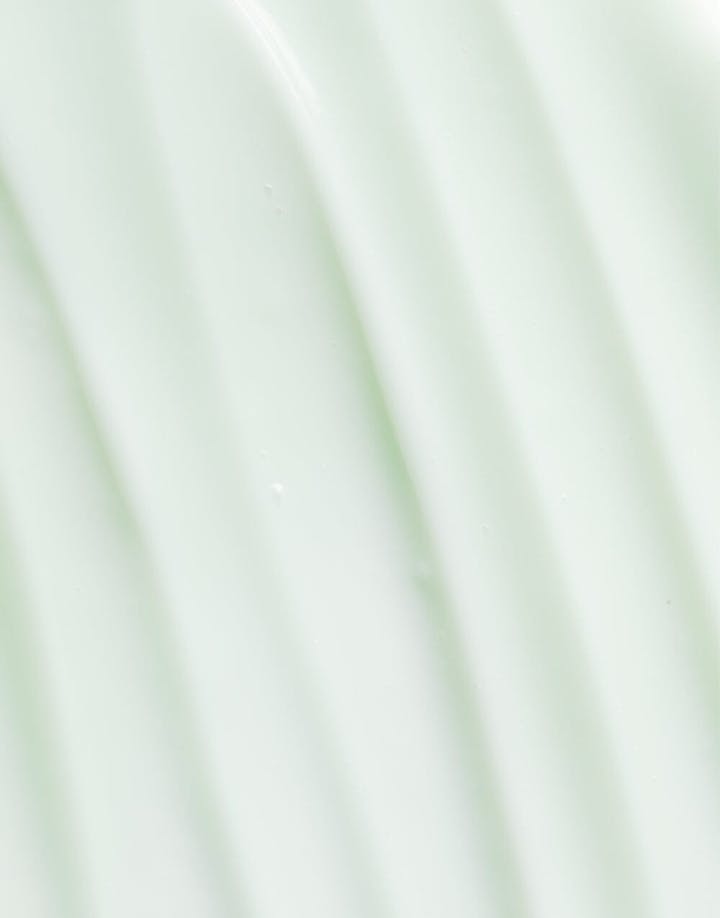 OSEA Ocean Cleanser bottle on soft gradient mint green background with vertical ripples