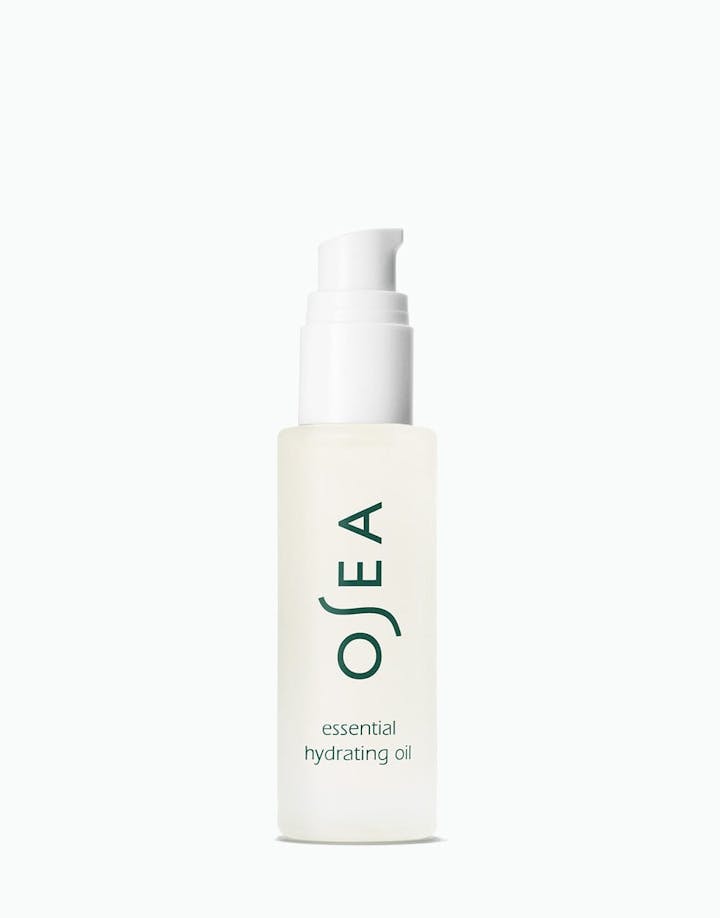A pump bottle of OSEA essential hydrating oil on a white background.