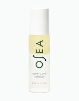 A bottle of OSEA Ocean Wave Cleanser with a yellowish liquid visible through the clear packaging