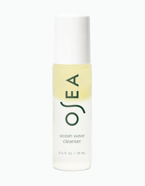 A bottle of OSEA Ocean Wave Cleanser with a yellowish liquid visible through the clear packaging