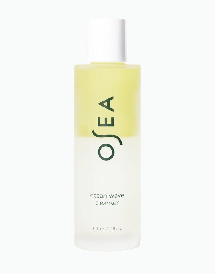 A bottle of OSEA Ocean Wave Cleanser with a yellowish liquid visible through the clear packaging, 