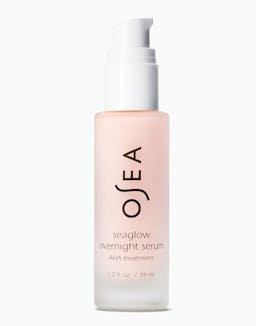 OSEA Seaglow Overnight Serum AHA Treatment in frosted blush bottle with white pump on white background