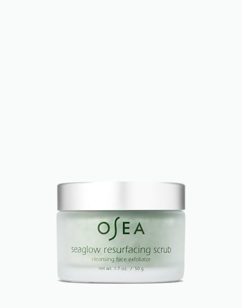 OSEA Seaglow Resurfacing Scrub in a frosted green jar with silver lid on white background