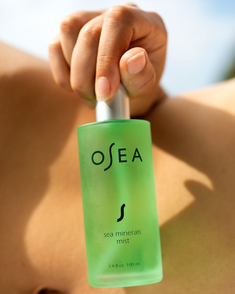 Sea Minerals Mist being held on beach