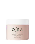 A container of OSEA salts of the earth body scrub with minimalistic design in a pink hue.