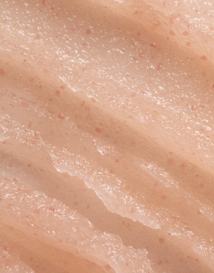 Detailed view of OSEA body scrub texture with visible salt crystals on skin