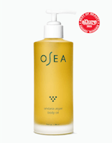 Yellow bottle of OSEA undaria algae body oil with a pump on a white background, featuring the Allure Best of Beauty Award 2023 badge.