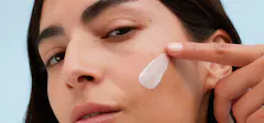 Woman Applying A Cream To Her Face