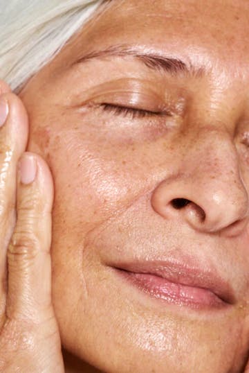 Woman Touching Her Face With Her Hands