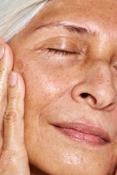Woman Touching Her Face With Her Hands