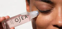 Woman Applying OSEA Eye Serum To Her Eyes