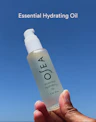 Essential Hydrating Oil applied to skin, showing smooth, nourishing texture absorbing for a radiant finish