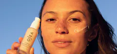 Woman Holding A Bottle Of Serum