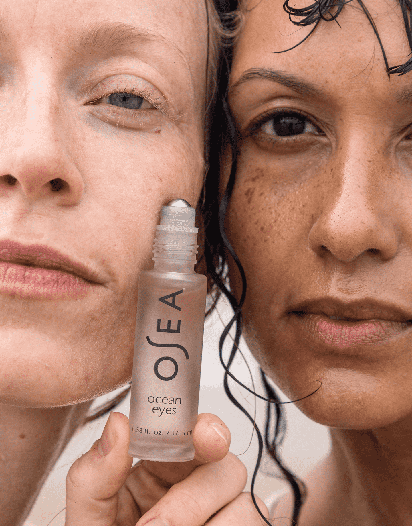 Two models holding Ocean Eyes Eye Serum and smiling at camera