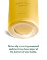 Close-up of bottle base noting naturally occurring seaweed sediment may be present